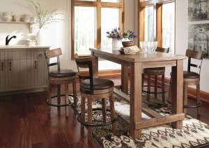 Pinnadel natural wood finish counter table with swivel seat bar stools in a kitchen next to a window.