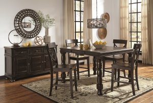 dark brown rectangle kitchen table and bar chairs with a server against the wall and a rug under the table.