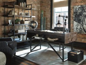 Urban designed office setting with a desk and a bookcase on one will topped with industrial sculptures such as globes, lamps and sculptures.