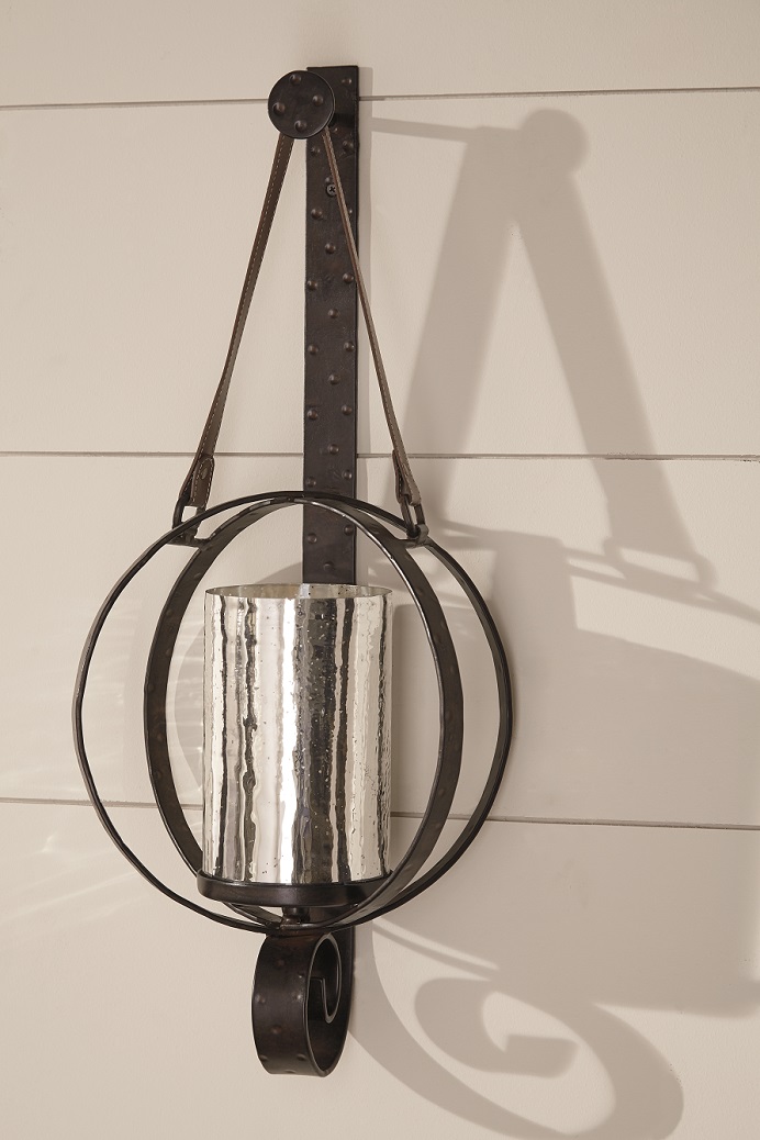 wall sconce made with dark brown metal circles and mercury glass
