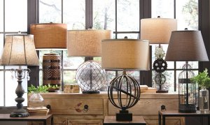 metal and glass table lamps on a console table
