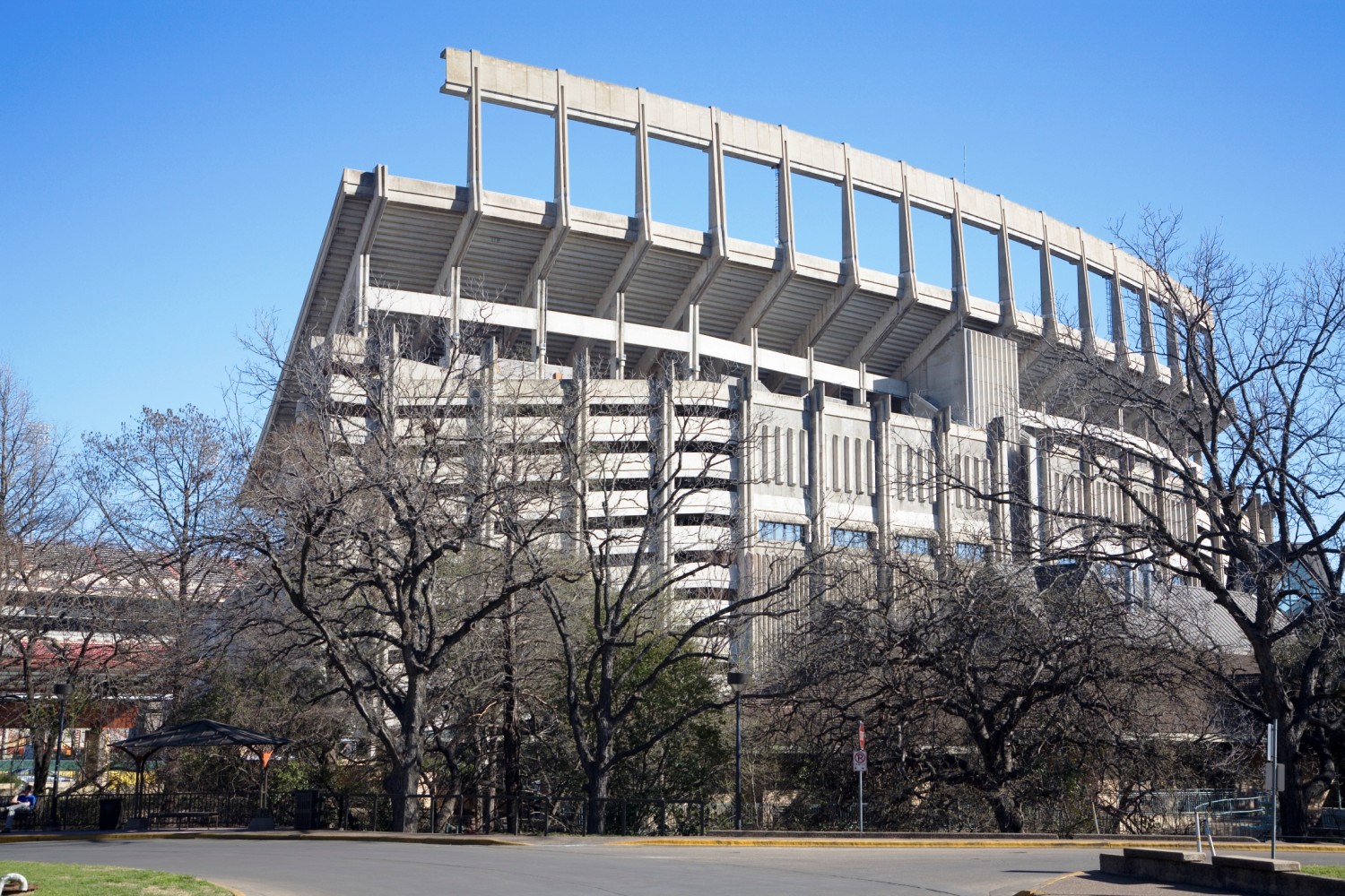 This photo was taken in late February, well before the trees began to leaf out - which allow the viewer to see through the trees.  In the lower ldeft portion of the photo, it should be noted that the north endzone seating has been demolished, and the University of Texas is preparing to add two levels of seating there, complete with clubhouses. This photo was taken from the East Mall fountain, and the Texas Exes Alumni Center is seen to the lower right.