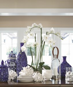 White dinnerware accented by blue ceramic vases.