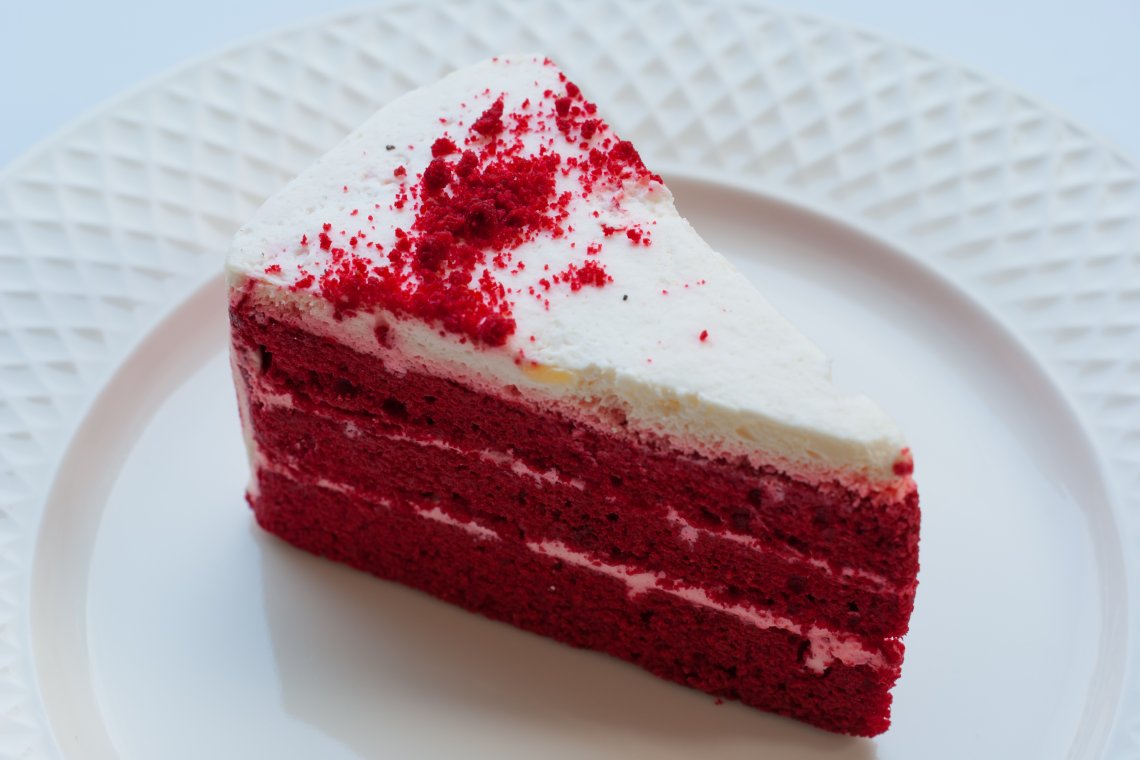 Red velvet cake on a white plate.