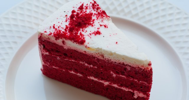 Red velvet cake on a white plate.