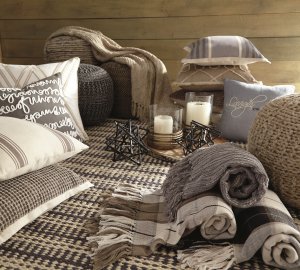 assorted accessories such as throws, pillows, candles and decor pieces.