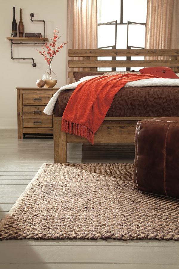 vintage aged brown finish on these open slat king headboards and nightstands in a room with a rug. 