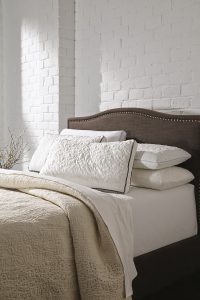 Assorted ashley pillows on an ashley mattress