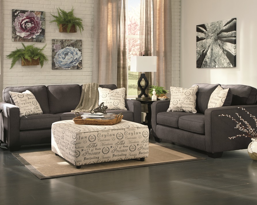 Charcoal black Alenya couch, oversized ottoman, and loveseat in a casual living room set