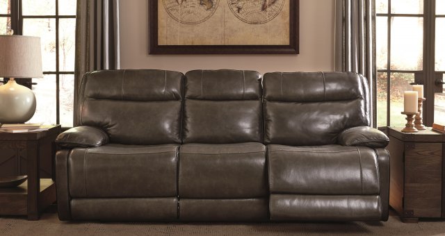 Leather reclining sofa with dim lights and masculine vibe with a map in a frame on a wall.