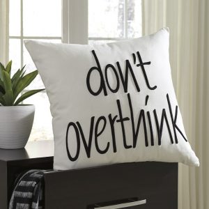 White throw pillow with text, "dont over think"