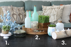 Coastal coffee table display with 3 sets of decor.