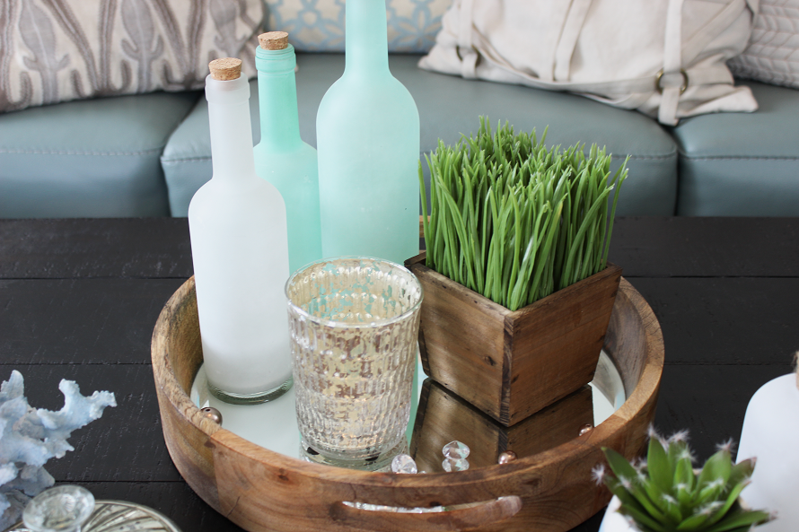 Close up of glass bottles used to decorate a coffee table. 