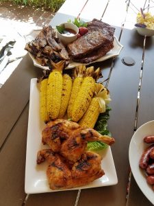 Grilled food staged on an outdoor table for 4th of july.