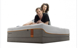 Image of professional snowboarder and volleyball player on a tempur-pedic mattress.