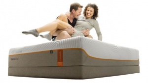 Professional snowboarder and volleyball player on a tempur-pedic mattress being goofy.