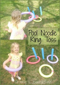 Pool noodle ring toss being played by a little girl in the yard.