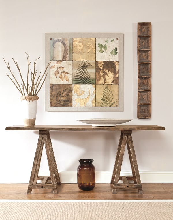 Brown minimalist sofa table with boho and coastal decor on top.