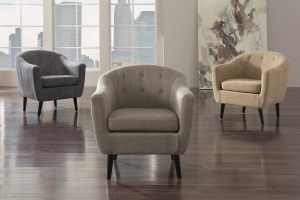 multiple tufted accent chairs in an empty room.
