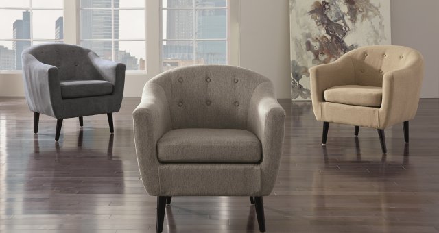 multiple tufted accent chairs in an empty room.