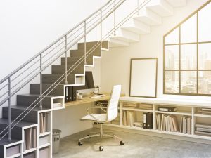 Workplace with a computer under the stairs, window to the right. City view. A blank frame under the stairs. Filter. Concept of work. 3D rendering