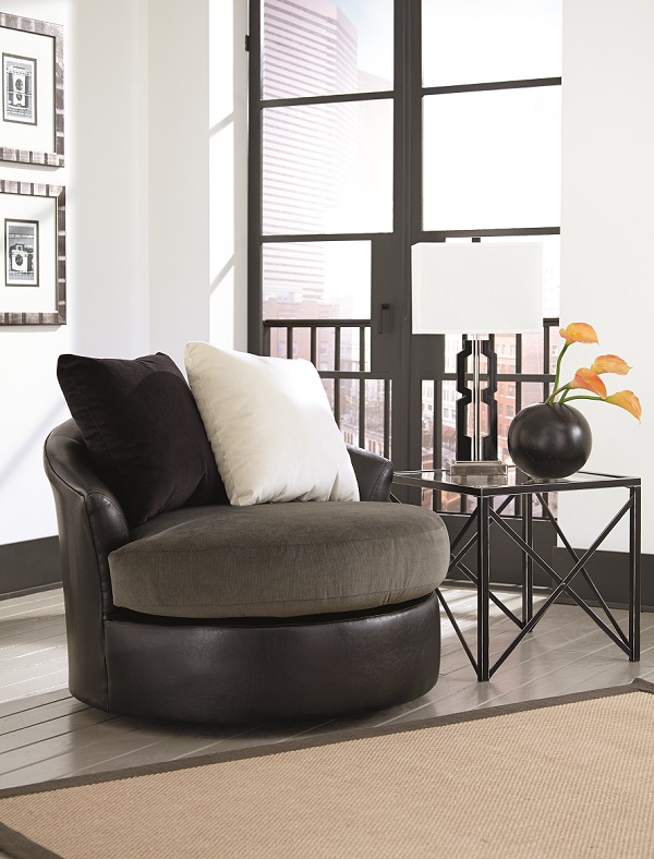Black swivel chair in a small space with fluffy chairs on top.