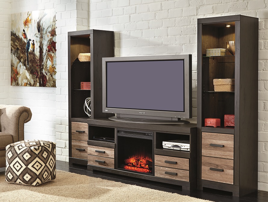 two tall shelving units sideline this TV stand on this entertainment center set with fireplace insert