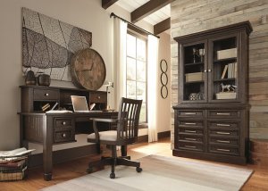 dark wood office set up with a bookcase vanity