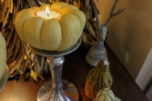 Decorative fall candle made from a mini pumpkin