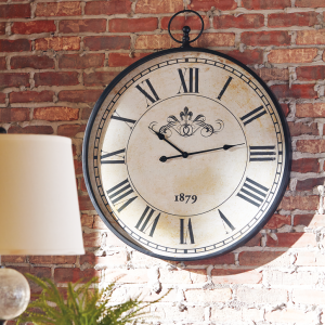 Large wall clock on a brick wall.