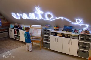 A kids play room with light up words on the word that say "Create".