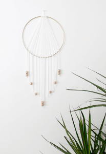 DIY dream catcher handing on a wall.