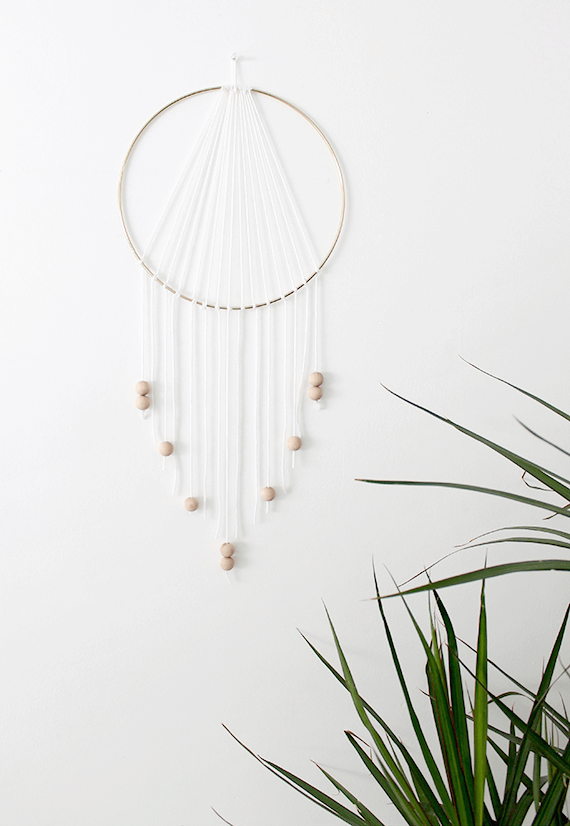 DIY dream catcher handing on a wall.