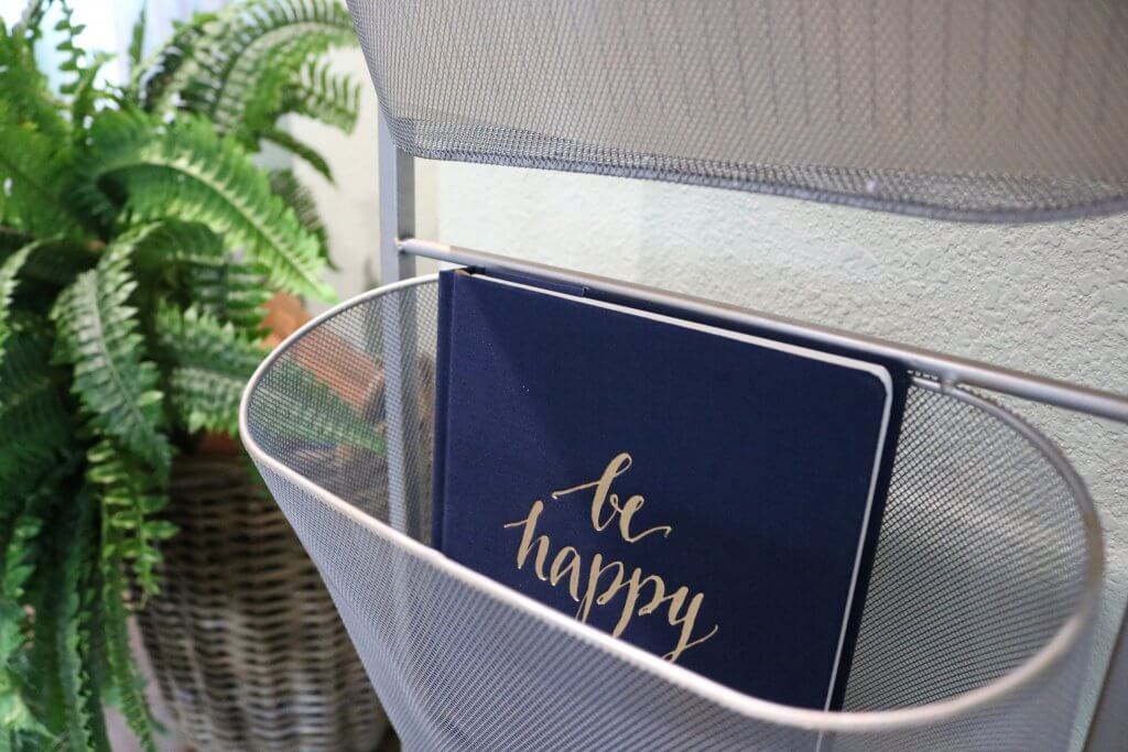 blue notebok with be happy written on it