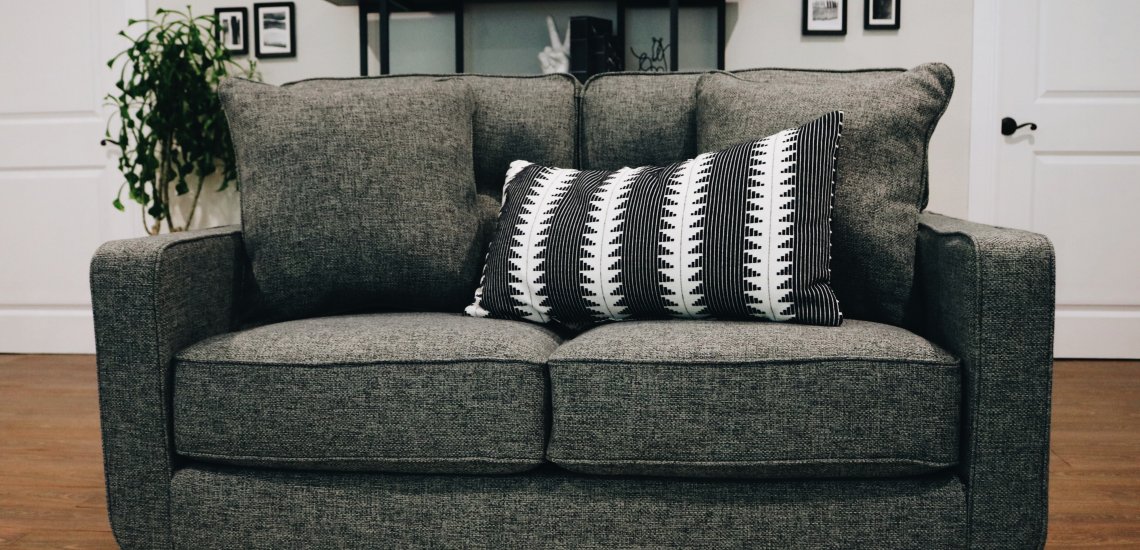 grey couch with black and white pillow