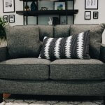 grey couch with black and white pillow