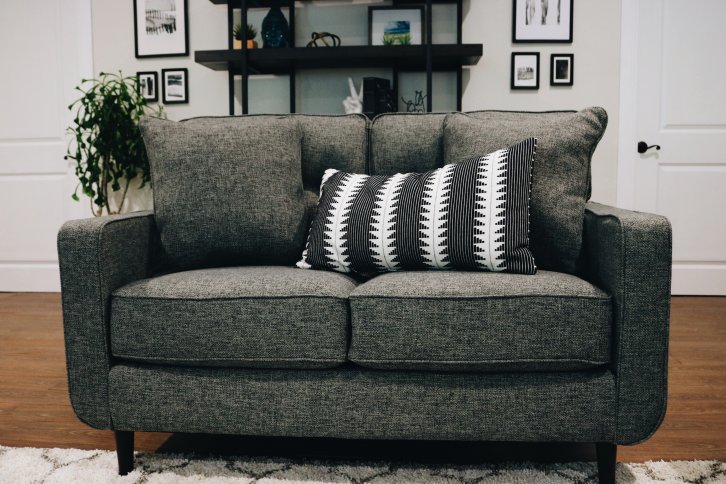 grey couch with black and white pillow