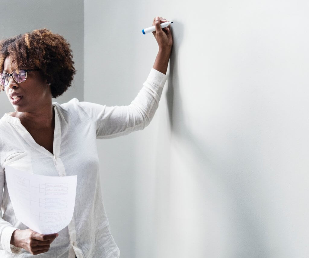 teacher writing on white board