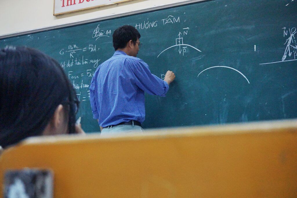 teacher writing on board