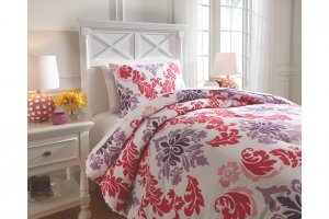 pink, purple, and white comforter set on white bed