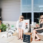 women on outdoor furniture with wine