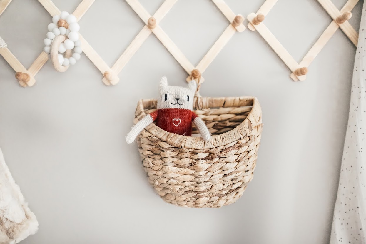 Toy in ornate straw basket. 