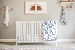 Baby crib with neutral decor.