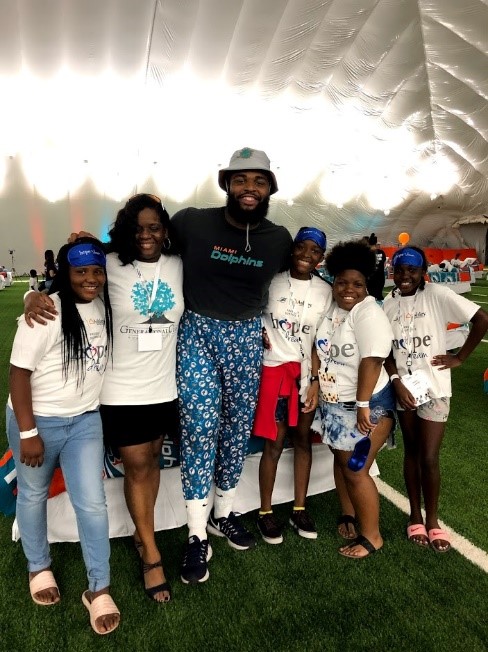 Christian Wilkins poses with children and parents.