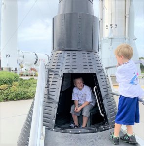 Brothers take turns exploring The Rocket Garden.