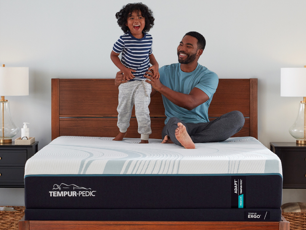 Father and son on a Tempur-Pedic mattress